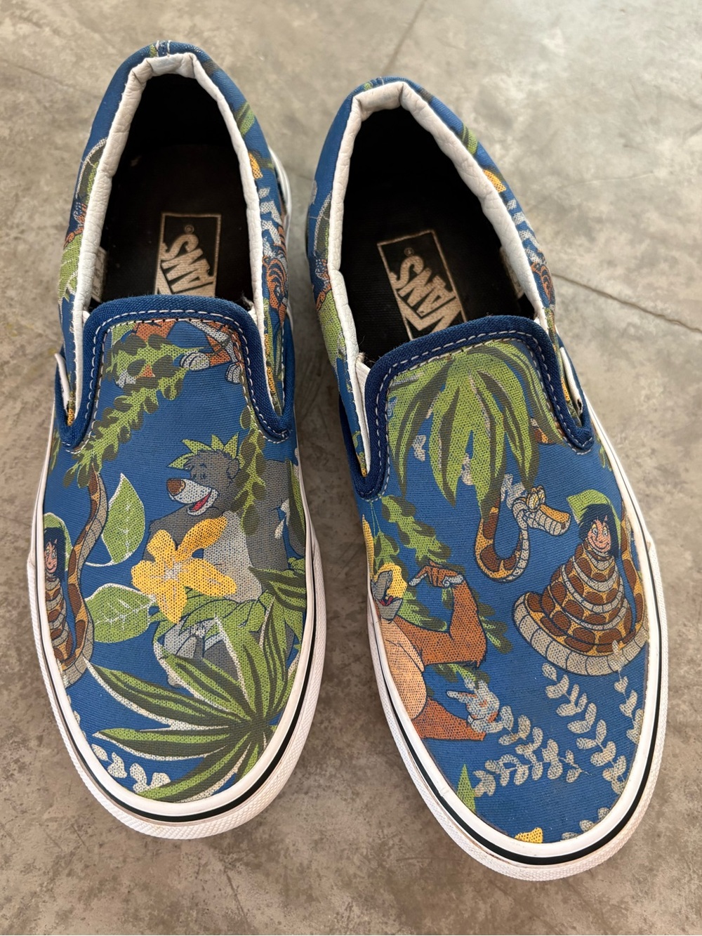 Rare Vans Disney Jungle Book slip-on sneakers featuring a vibrant blue jungle